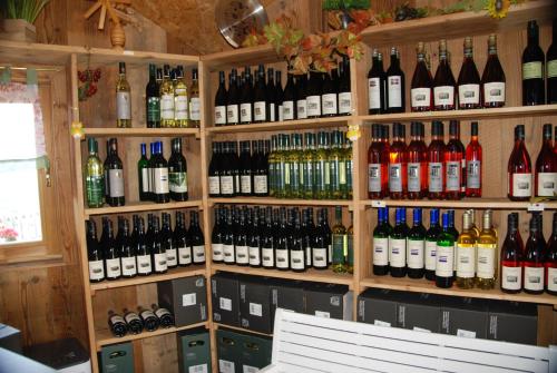 a bunch of bottles of wine on a wall at Weinberg-Panorama- Camping in Höch
