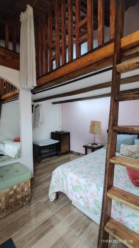 a bedroom with two bunk beds and a ladder at Casa Barbosa Paraty in Paraty
