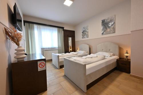 Ένα ή περισσότερα κρεβάτια σε δωμάτιο στο Hotel Lane