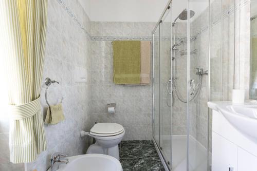 a bathroom with a shower and a toilet and a sink at TRENTINO LODGE Via San Vito in Strigno