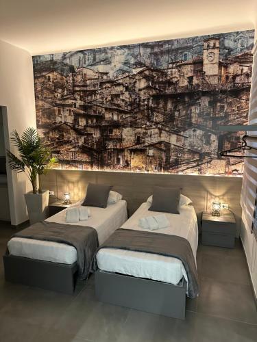 a bedroom with two beds and a wall mural at Suite degli Archi - Genova Fronte Acquario in Genova