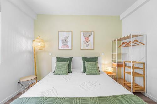 a bedroom with a large bed with green pillows at Green Living-Funchal in Funchal