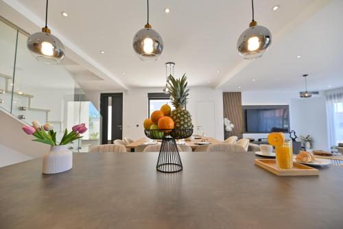 a table with a bowl of fruit on top of it at Villa Oasis in Trogir