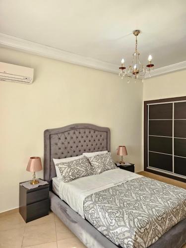 a bedroom with a bed with two night stands and two lamps at City Center Apartment in Tangier