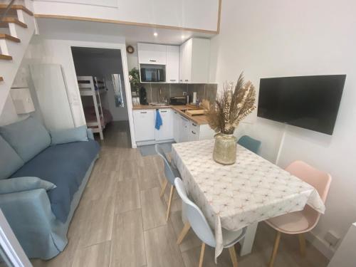 un salon avec une table et un canapé bleu dans l'établissement La Casita 46, à Saint-Hilaire-de-Riez