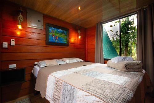 a bedroom with two beds and a tv on the wall at Betulio's Oasis in Fortuna