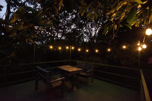 a table and chairs on a fence with lights at Betulio's Oasis in Fortuna
