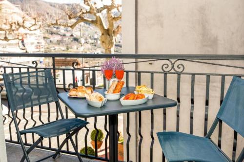 a table with food and drinks on a balcony at Casa Nonna Lucia in Pianillo