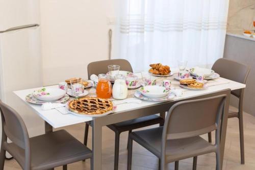 a white table with plates of food on it at Casa Nonna Lucia in Pianillo