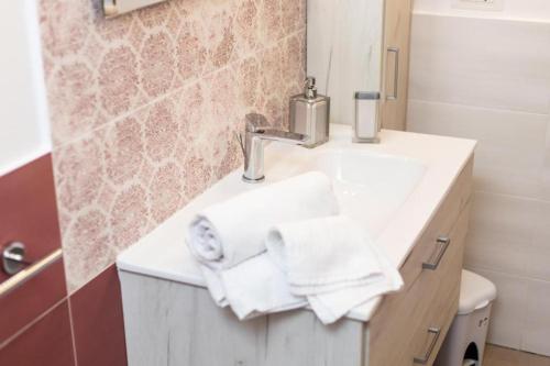 a bathroom with a sink with towels on it at Casa Nonna Lucia in Pianillo