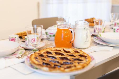 a table with a waffle and a jug of orange juice at Casa Nonna Lucia in Pianillo