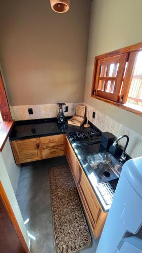 a kitchen with a stove and a counter top at Vila São Jorge in Barra Grande