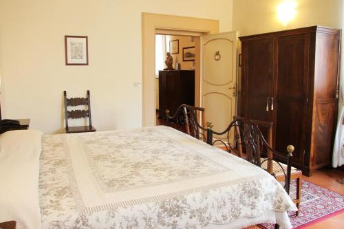 a bedroom with a bed and a dresser and a door at B&B L'Agnolo Di Caroti Cinzia in Montepulciano