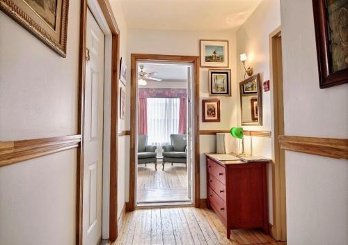 a hallway with a door leading to a living room at Auberge de la Vieille Maison in Rimouski