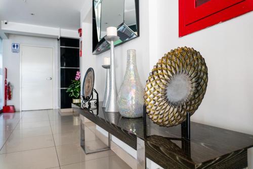 a room with vases on a glass table at Apart Hotel Petit Palace Suites in Lima