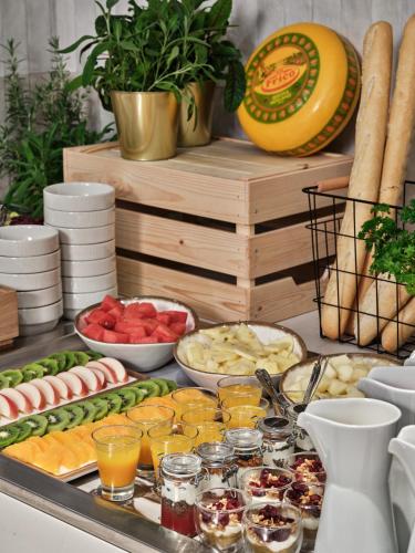 a buffet with different types of food on a table at Mövenpick Grand Hotel Wroclaw in Wrocław