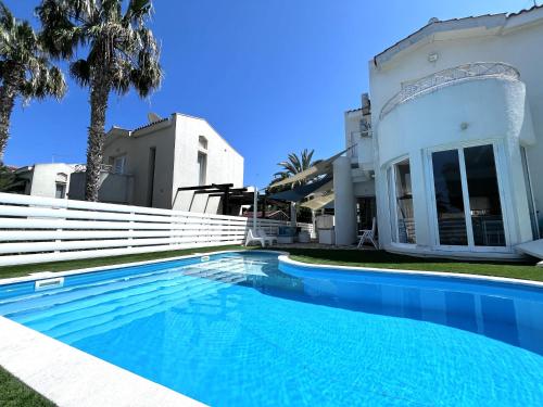 a swimming pool in front of a house at STAY ALKYONI Villa in Protaras