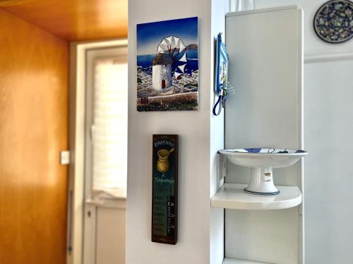 a bathroom with a sink and a picture on the wall at STAY ALKYONI Villa in Protaras