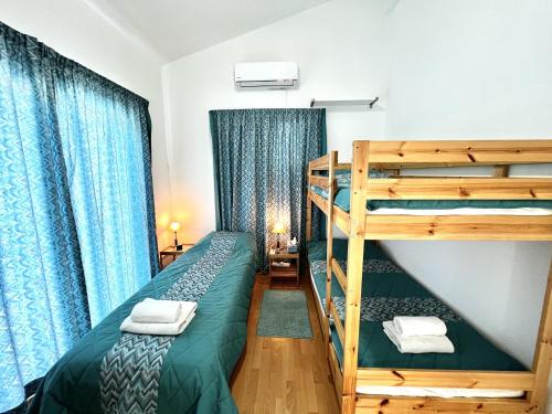 a bedroom with two bunk beds and a ladder at STAY ALKYONI Villa in Protaras