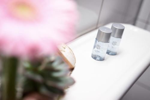 a close up of two bottles ofodorizers on a sink at Hotel Zum Eisenhammer in Oberhausen
