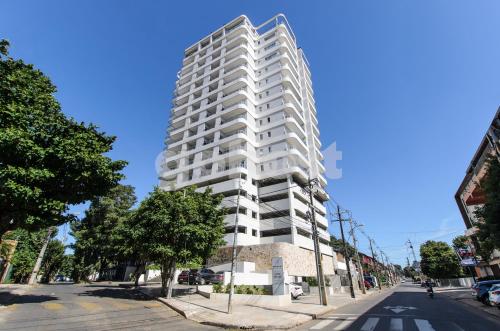 a tall white building on the side of a street at Fully Equipped Apt Close To Paseo La Galeria in Asuncion
