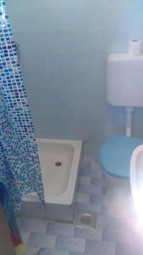 a bathroom with a shower with a toilet and a tub at Peaceful House in Tribunj in Tribunj