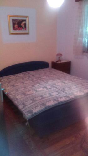 a large bed in a room with a table at Peaceful House in Tribunj in Tribunj