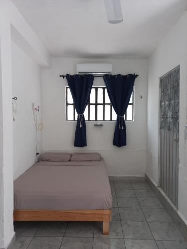 a bedroom with a bed and a window at white house in Valladolid