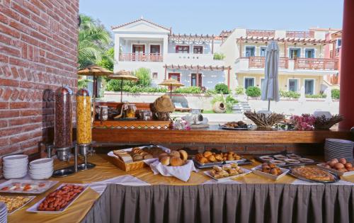 a table with a buffet of food on it at Sirena Residence & Spa in Marathokampos