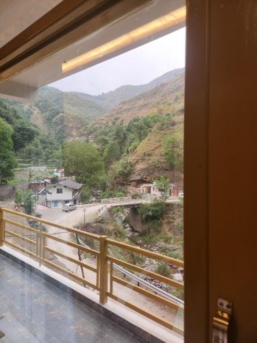 a view of a mountain from a window at Neerangana Retreat in Chakrāta