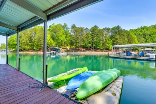 a dock with two boats on the water at Beautiful Lake Keowee Home with Boat Dock and Fire Pit in Seneca