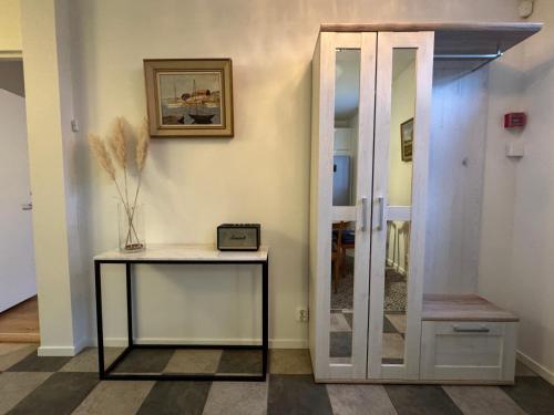 a hallway with a table and a glass door at Spacious & elegant apartment in a stable at Kvarnviks Gård in Klagstorp