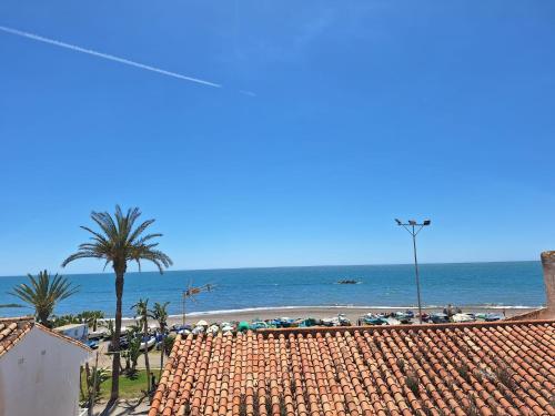 a view of a beach with umbrellas and the ocean at Casa Cala del Mar in Cala del Moral