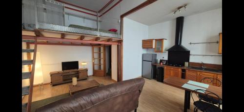 un salon avec un canapé et une mezzanine dans l'établissement avignon centre appartement 4 personnes, à La Celle-sous-Gouzon