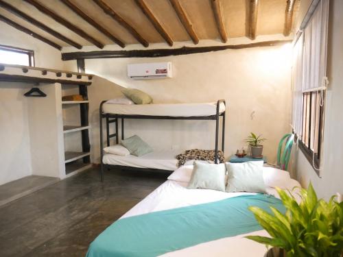a bedroom with two bunk beds in a room at Guacuco Living in El Hato