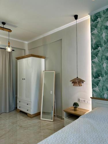 a bedroom with a mirror and a dresser and a bed at Samos Endless Blue 2 in Samos