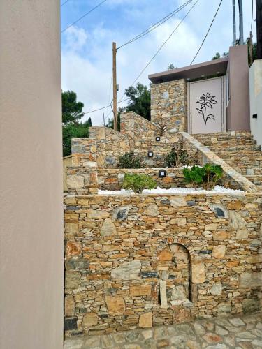 a stone wall with a stone oven in front of a building at Samos Endless Blue 2 in Samos