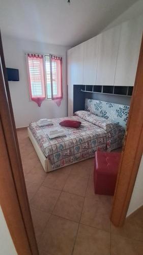 a bedroom with a bed and a mirror at Domo Susy in Orosei