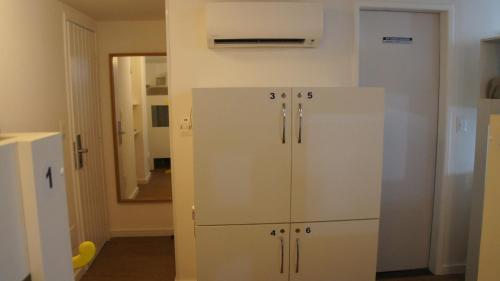 a white refrigerator in a room with a mirror at Hotel Saveiro in Recife