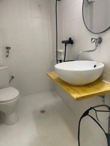 a bathroom with a white sink and a toilet at Sugar V 28 in Vergia