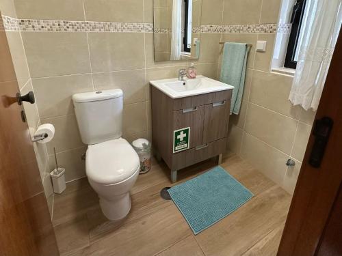 a bathroom with a toilet and a sink at Casa do Mar in Salema