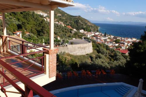 a balcony of a house with a view of the ocean at Agrabeli Apartments in Limne