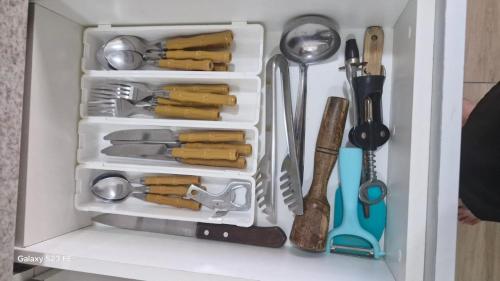 a white refrigerator filled with lots of kitchen utensils at Apt lindo e novo vista mar com garagem orla de Pituba in Salvador