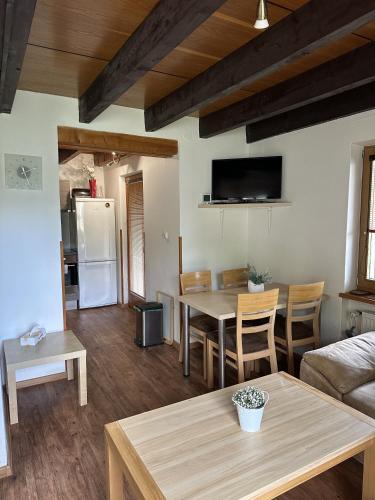 a living room with a table and a couch at Madlenka in Bělá pod Pradědem