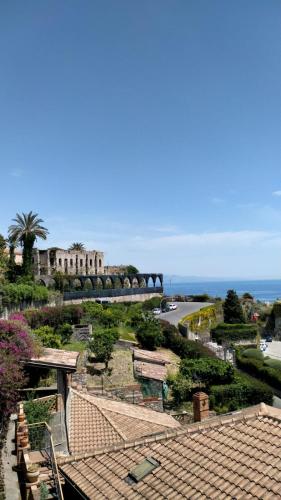 a view of a park with a building and the ocean at Villa Anna al Duomo in Taormina