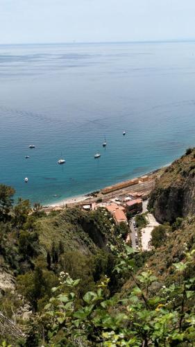 a view of a beach with boats in the water at Villa Anna al Duomo in Taormina