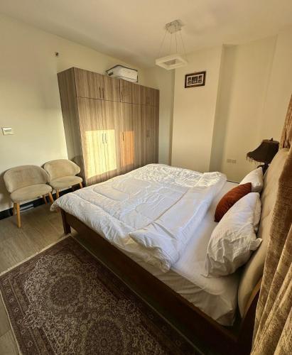 a bedroom with a large bed in a room at 1-Bedroom Family Apartment with Balcony in Sharjah in Sharjah