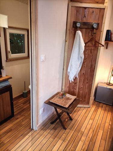 a room with a table and a wooden door at Oudoty in Kerlouan