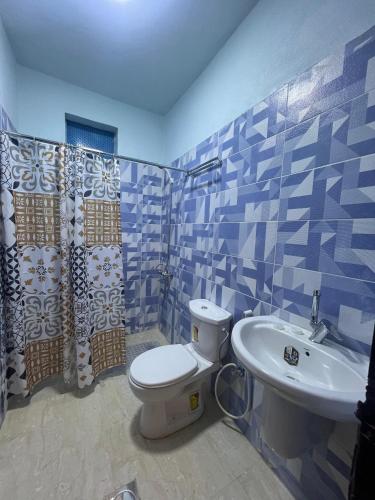 a bathroom with a toilet and a sink at Camel Dive Club By The Sea Inn in Jurf ad Darāwīsh