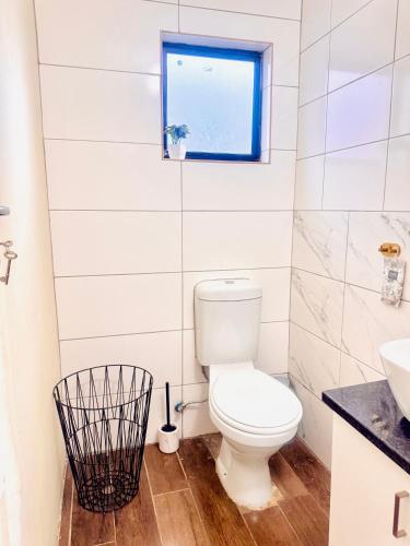 a bathroom with a toilet and a window at Private Studio in Cape Town, Near Canal Walk & Table Mountain in Cape Town